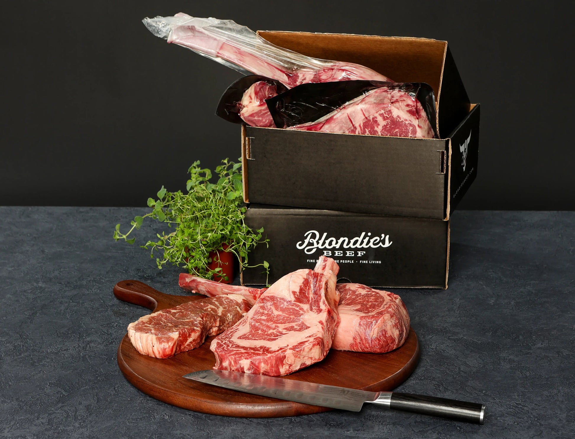 Blondie’s Beef Carnivore Box with thick Wagyu tomahawks and ribeyes displayed on a cutting board with branded packaging for meat lovers.